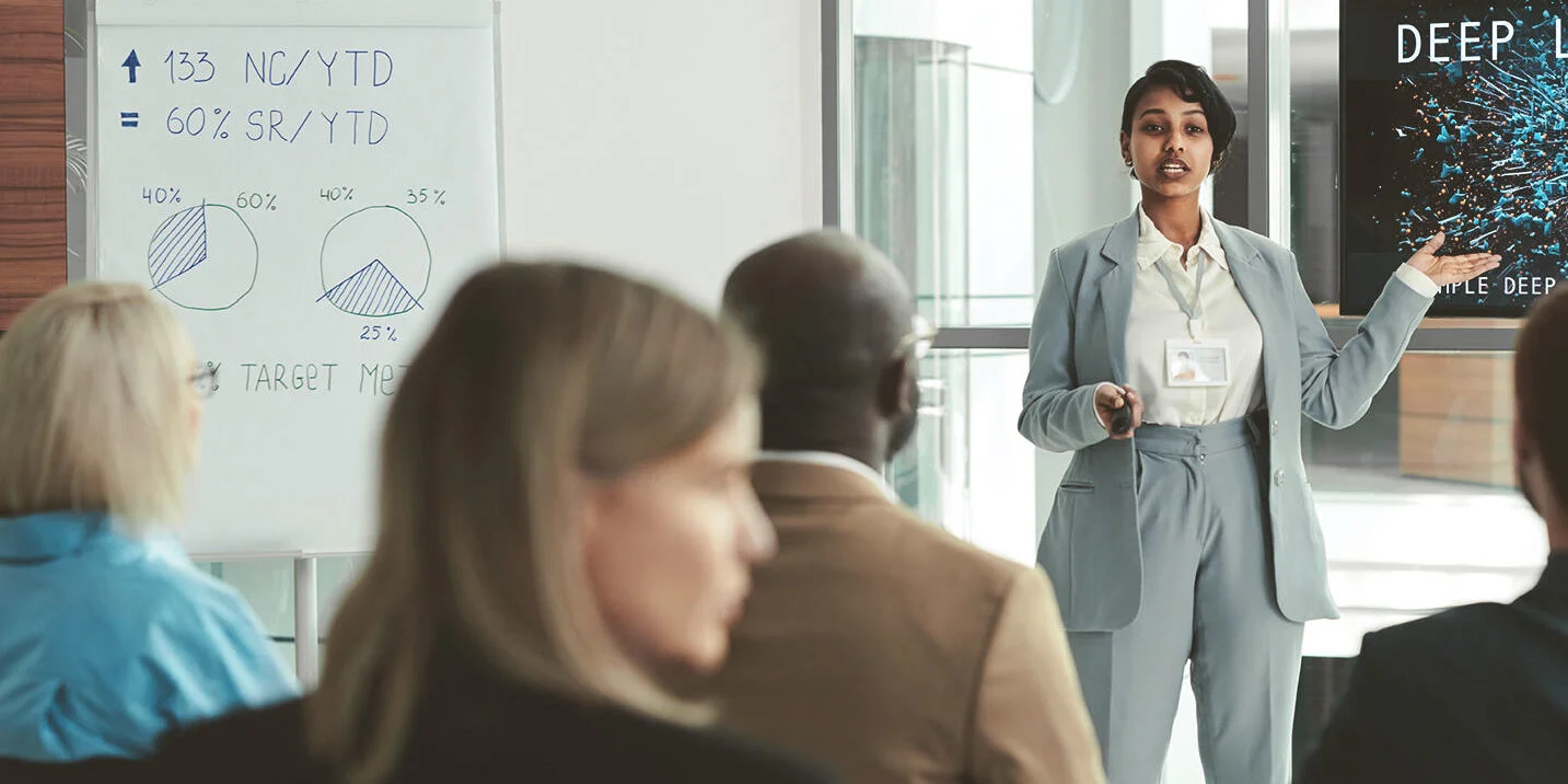 Woman presenting in front of colleagues