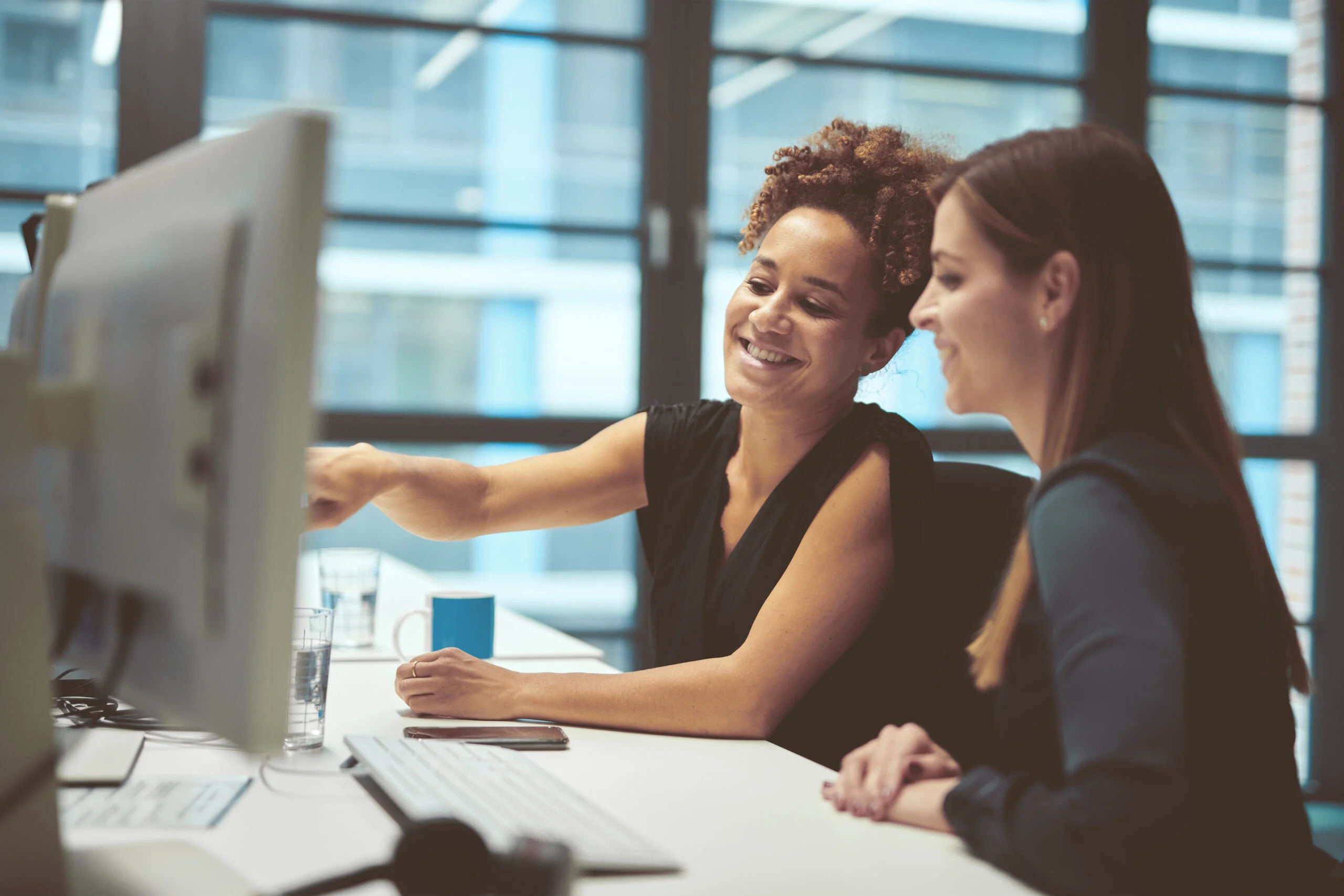 Two people in an office looking at a computer