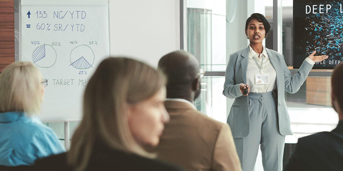Woman presenting in front of colleagues